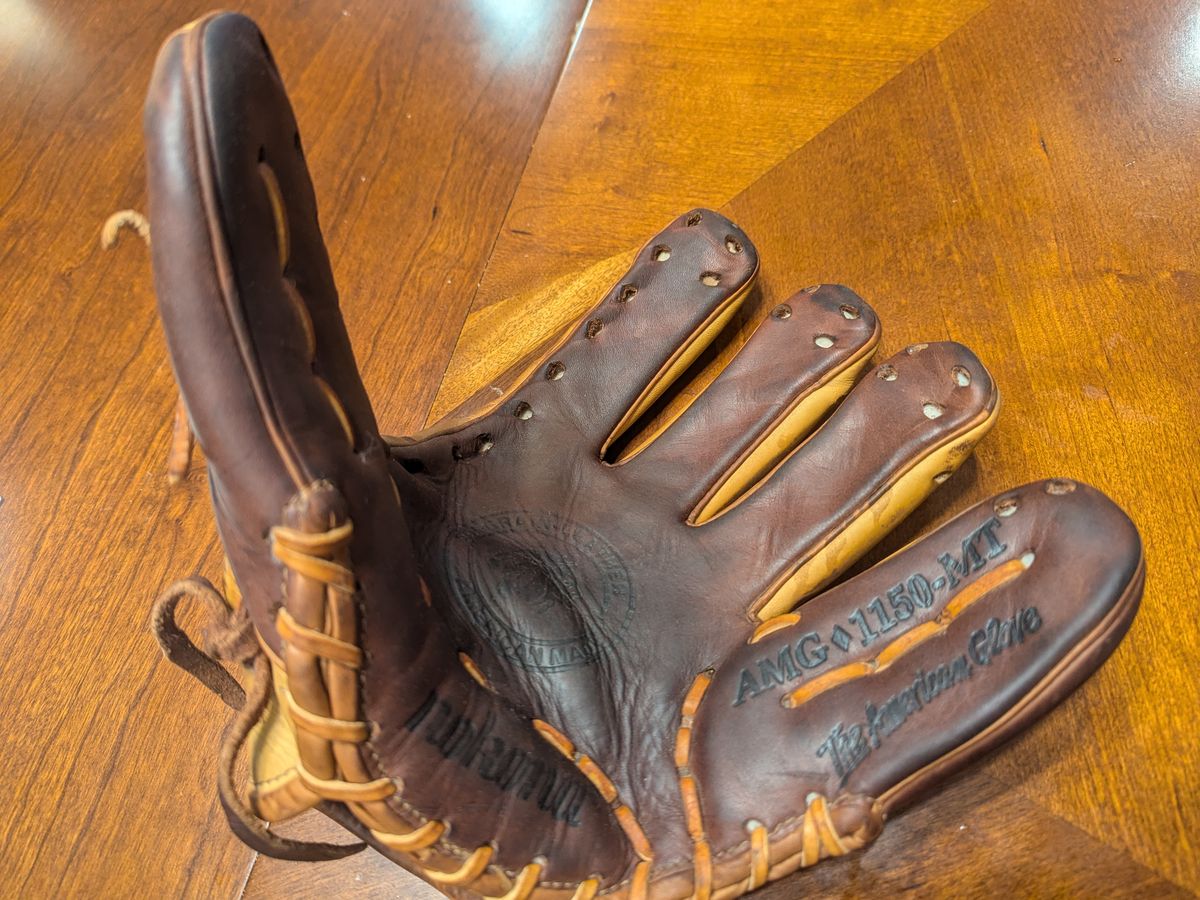 Nokona AMG-1150 baseball glove after a full relace with tan rawhide lace