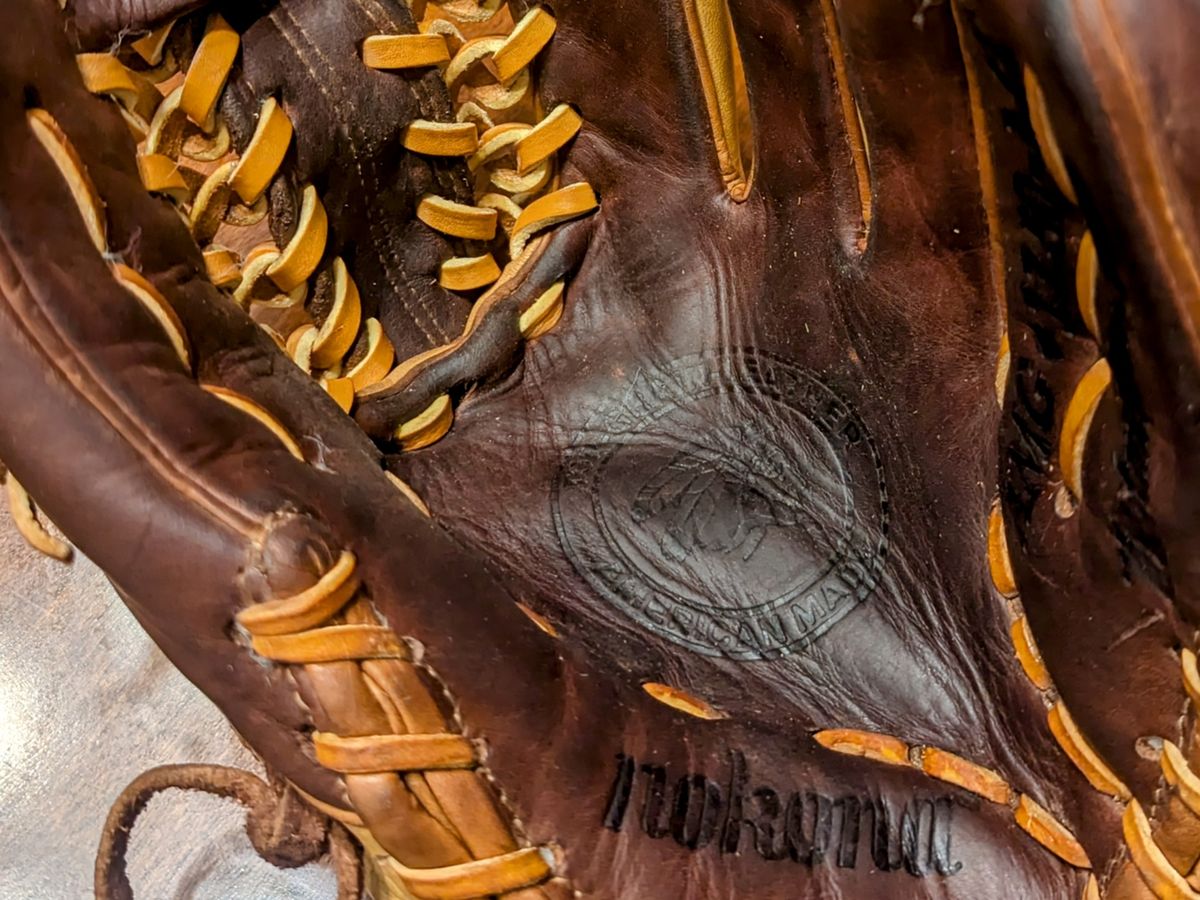 Close-up of fresh tan lace through the pocket of a Nokona baseball glove
